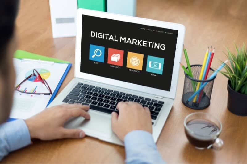 An image of a laptop showing digital marketing text