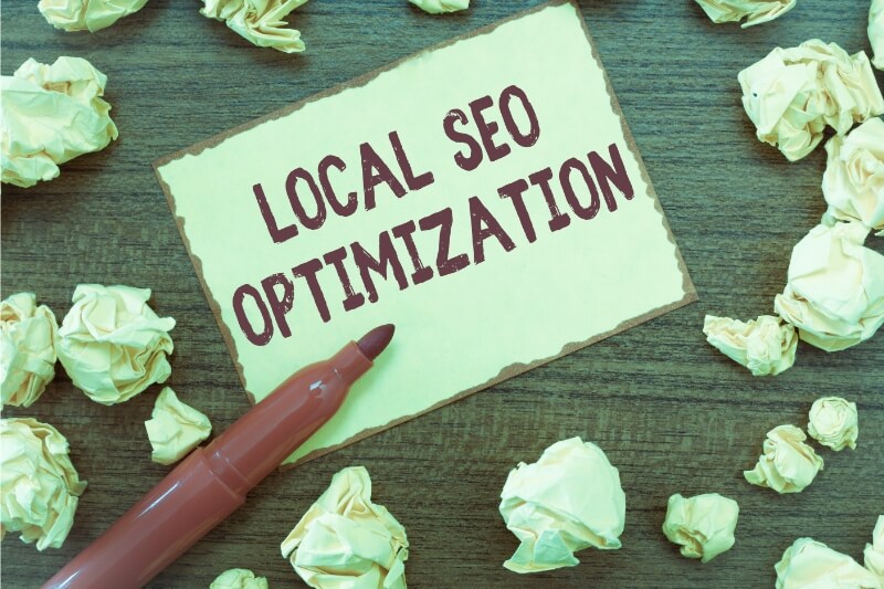 An image of a paper with local seo optimisation written on it to promote best local seo.