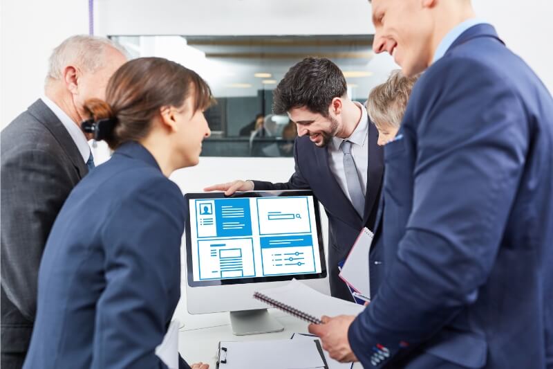 An image of business employees happy with their seo service due to increased business growth.
